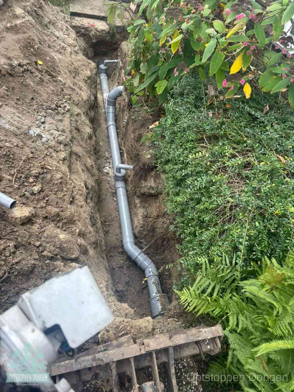 Open sleuf met nieuwe PVC-buizen, riool repareren en vervangen in Dongen